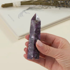 lepidolite crystal tower for sale held in a woman's hand